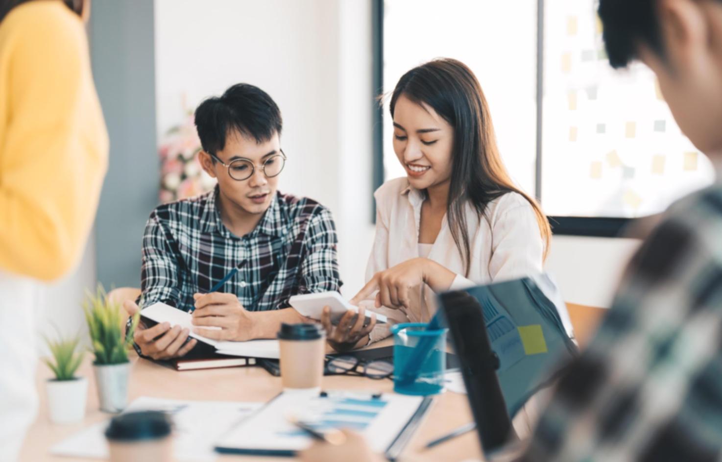 Person reviewing budget documents at kitchen table